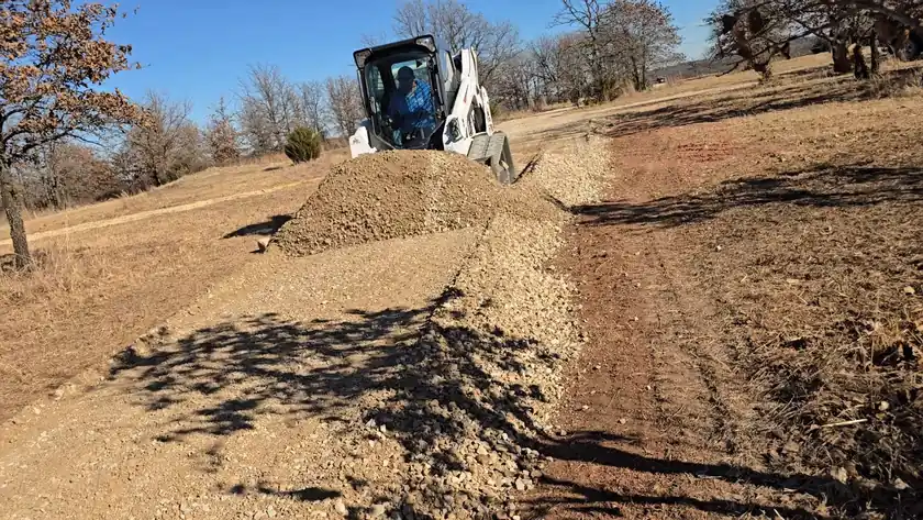 Heavy equipment performing site grading for a new residential build pad in Oklahoma